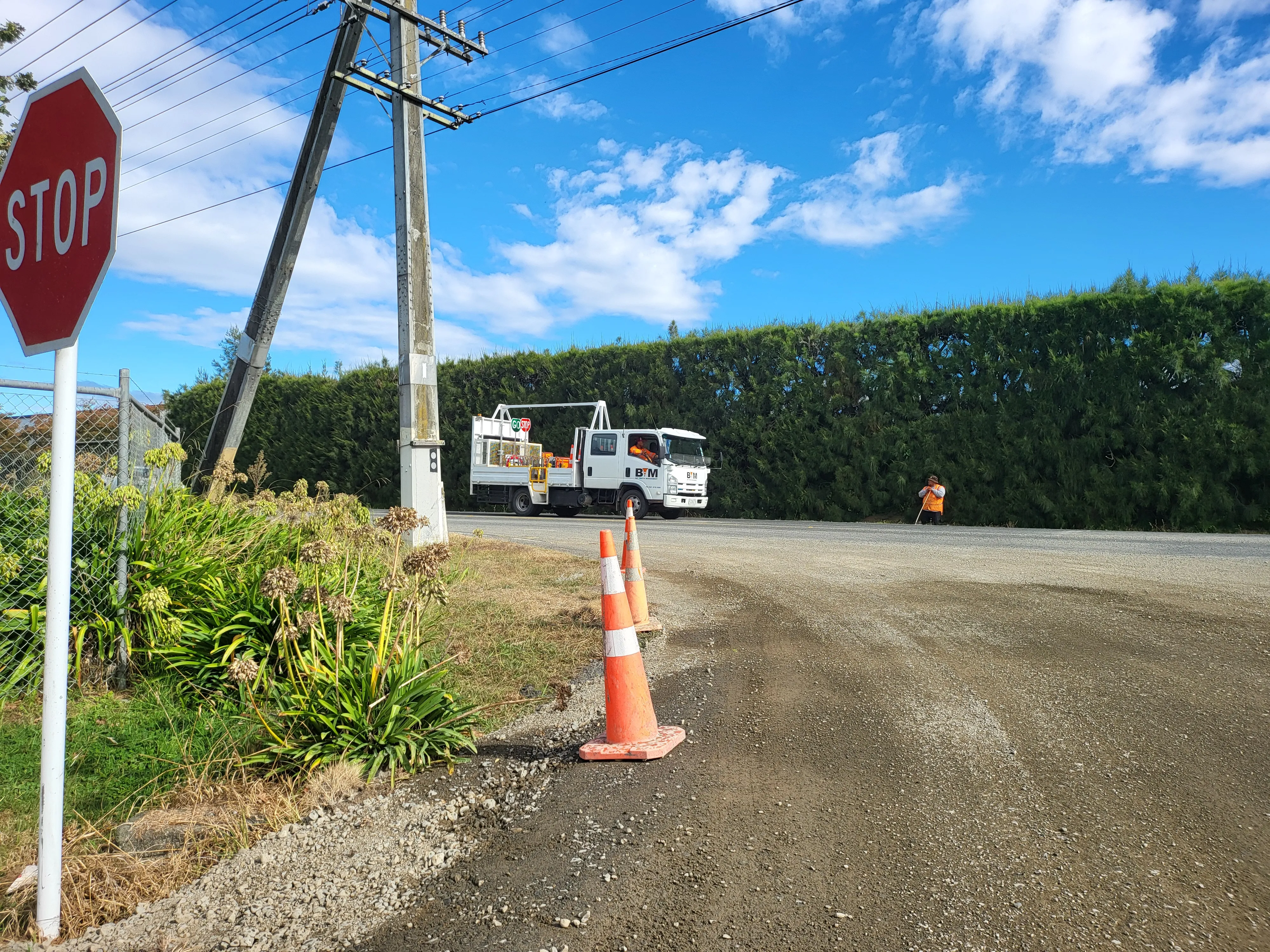 Stop sign and cones controlling access at a worksite