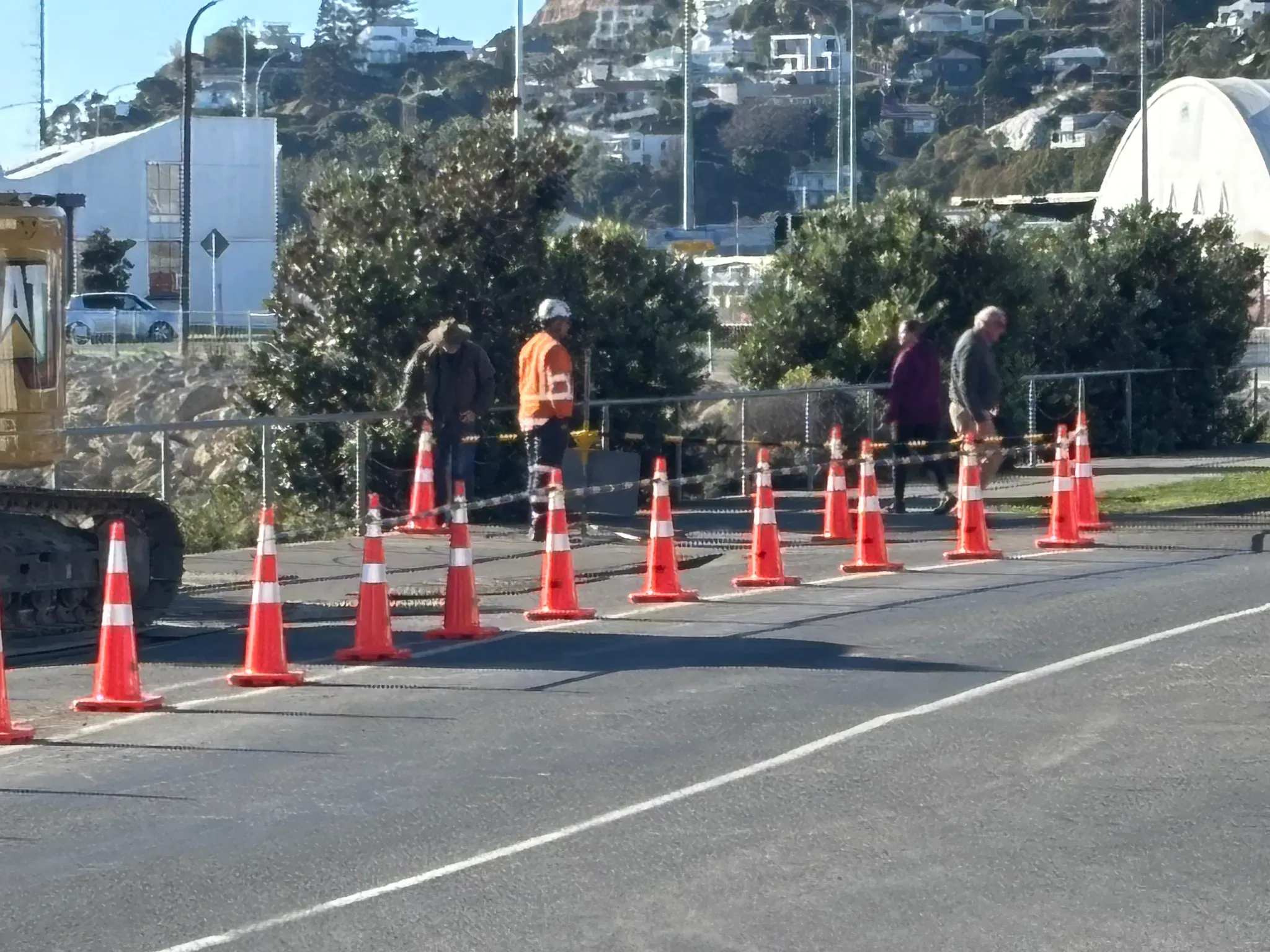 Traffic management crew managing a coned urban street